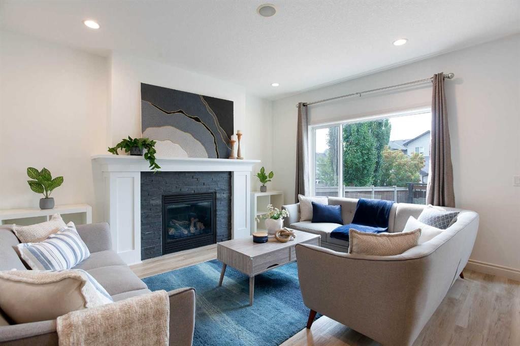 1153 Kingston Crescent Se, Airdrie, AB - Indoor Photo Showing Living Room With Fireplace