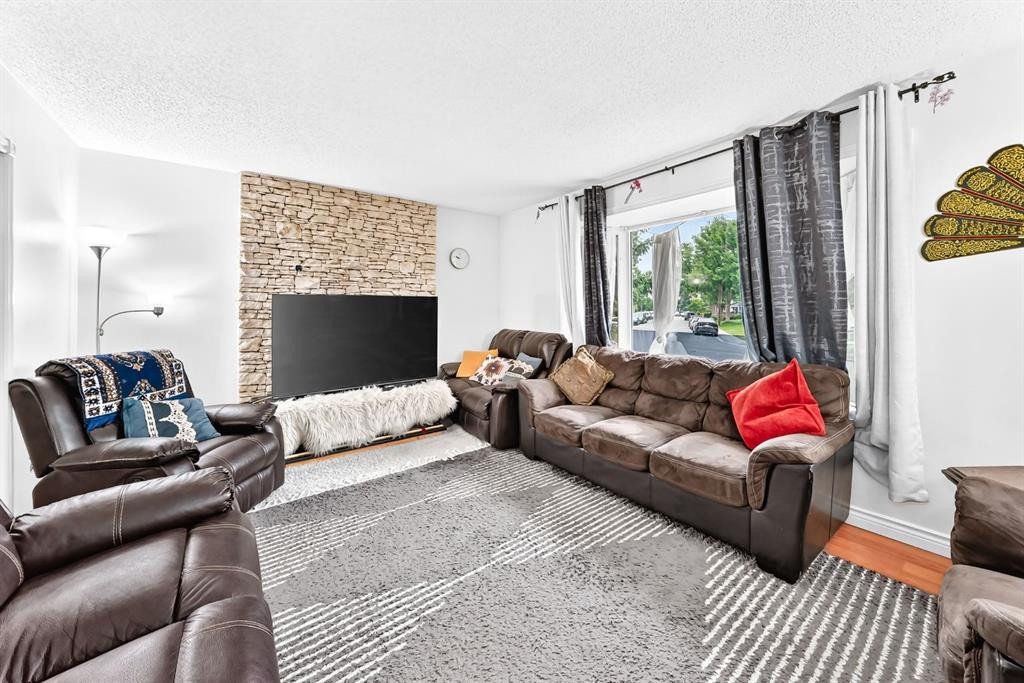 983 Rundlecairn Way Ne, Calgary, AB - Indoor Photo Showing Living Room With Fireplace