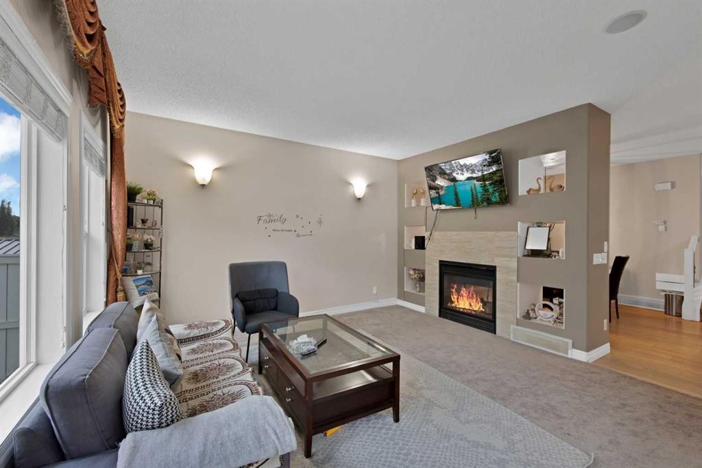 77 Saddleland Drive Ne, Calgary, AB - Indoor Photo Showing Living Room With Fireplace