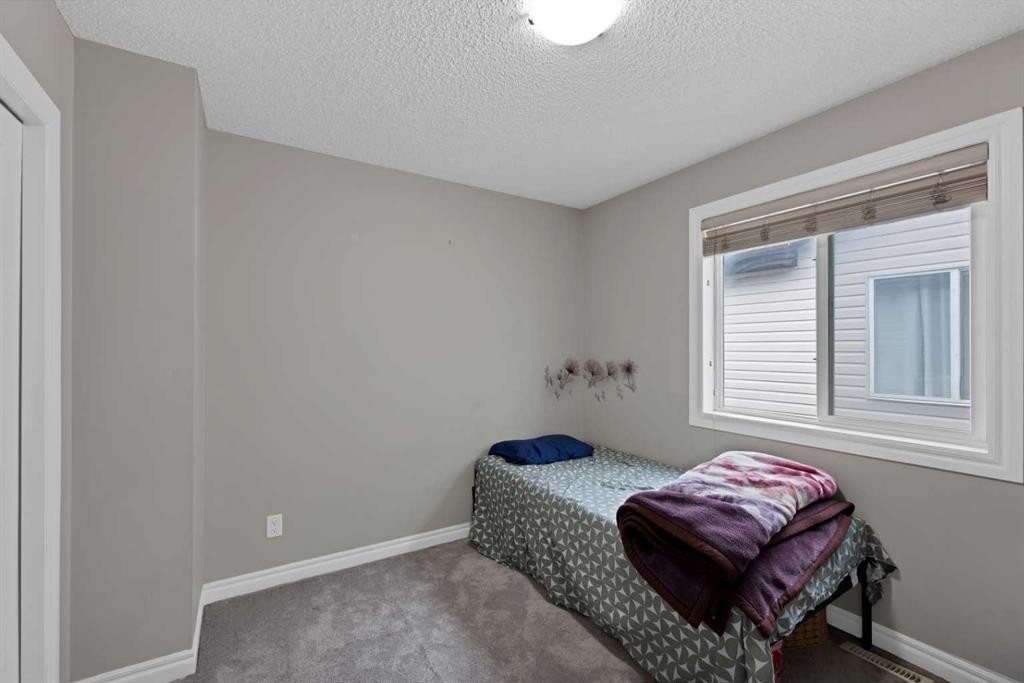 77 Saddleland Drive Ne, Calgary, AB - Indoor Photo Showing Bedroom