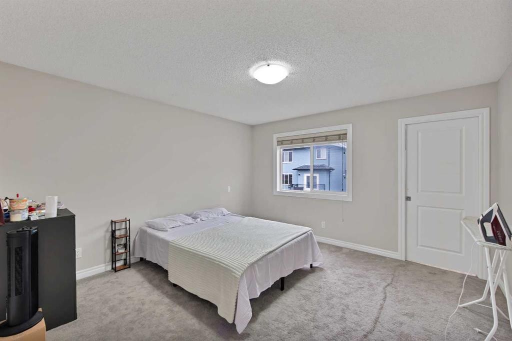77 Saddleland Drive Ne, Calgary, AB - Indoor Photo Showing Bedroom