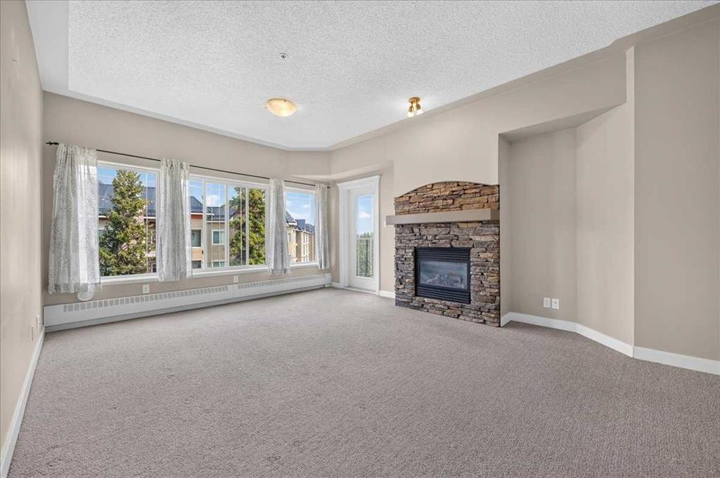 537-10 Discovery Ridge Close Sw, Calgary, AB - Indoor Photo Showing Living Room With Fireplace