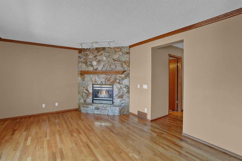 62 West Mitford Crescent, Cochrane, AB - Indoor Photo Showing Other Room With Fireplace
