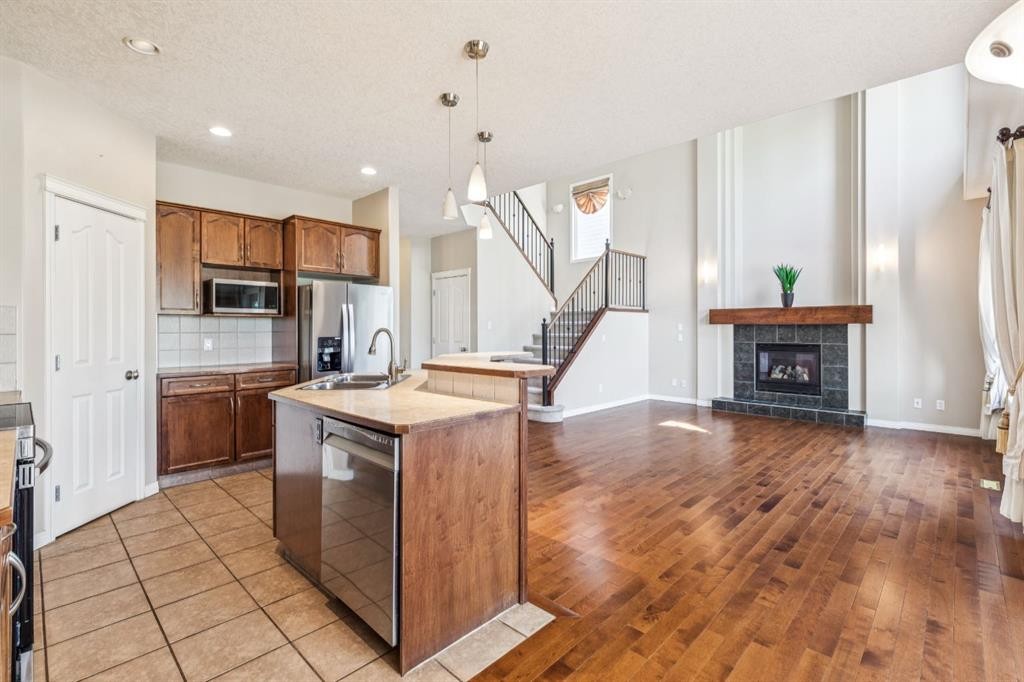 91 St Moritz Terrace Sw, Calgary, AB - Indoor Photo Showing Kitchen With Fireplace With Double Sink