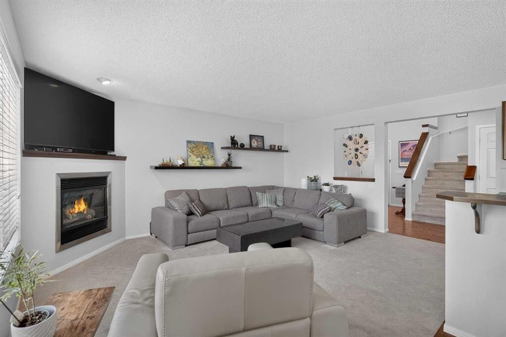 288 Evansbrooke Way Nw, Calgary, AB - Indoor Photo Showing Living Room With Fireplace