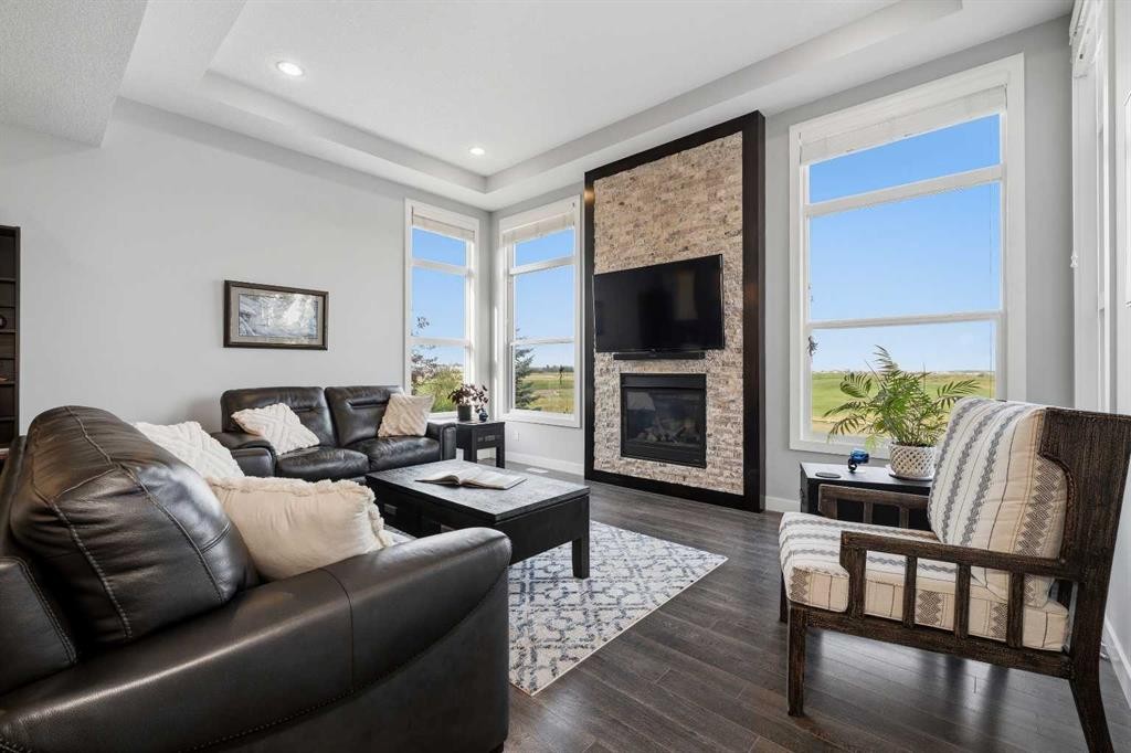395 Boulder Creek Bay Se, Langdon, AB - Indoor Photo Showing Living Room With Fireplace