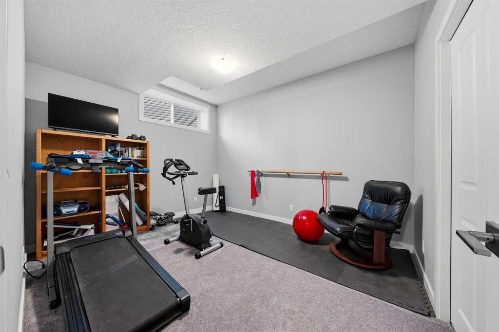 395 Boulder Creek Bay Se, Langdon, AB - Indoor Photo Showing Gym Room