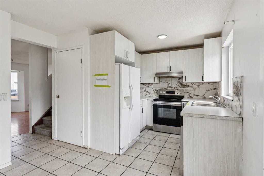 104 Falmere Way Ne, Calgary, AB - Indoor Photo Showing Kitchen With Double Sink