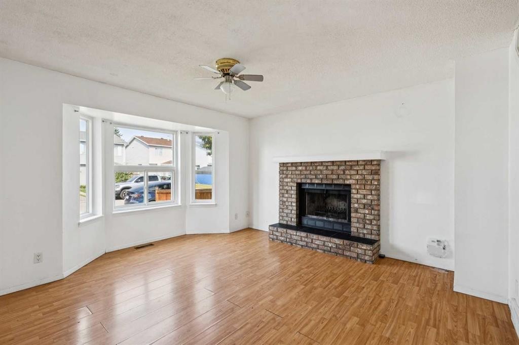 104 Falmere Way Ne, Calgary, AB - Indoor Photo Showing Living Room With Fireplace
