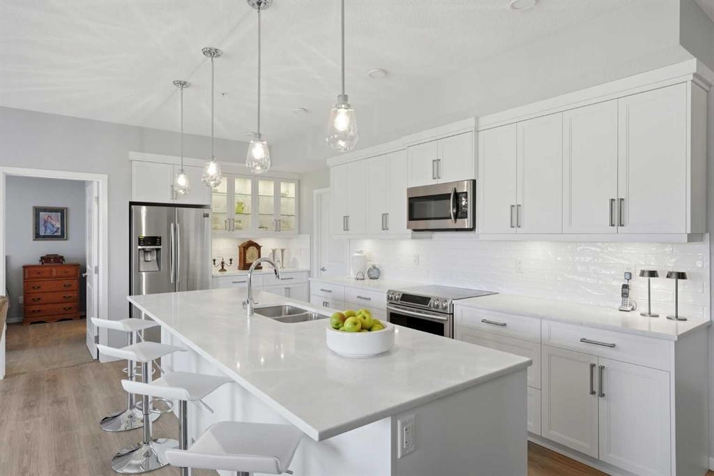 212-4150 Seton Drive Sw, Calgary, AB - Indoor Photo Showing Kitchen With Stainless Steel Kitchen With Double Sink With Upgraded Kitchen