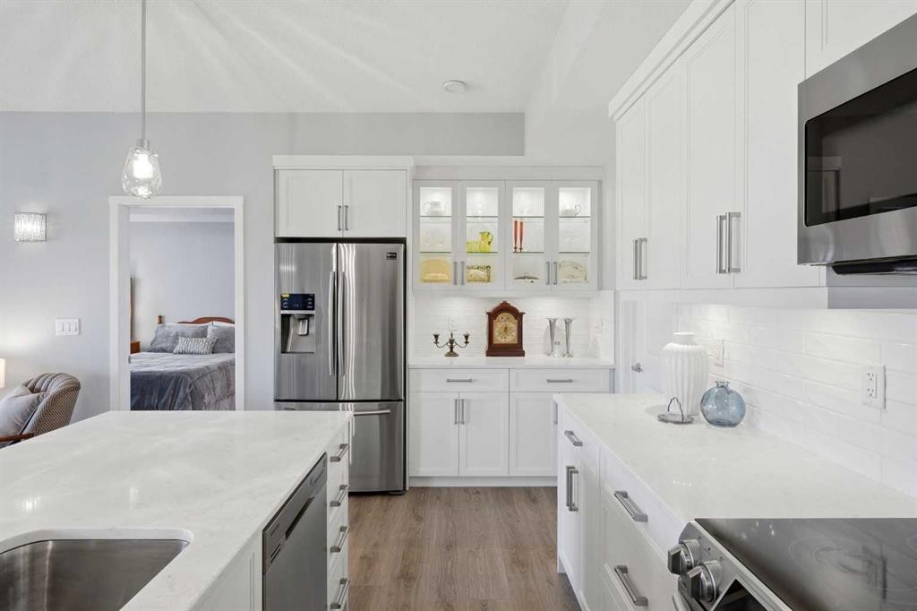212-4150 Seton Drive Sw, Calgary, AB - Indoor Photo Showing Kitchen With Stainless Steel Kitchen With Upgraded Kitchen