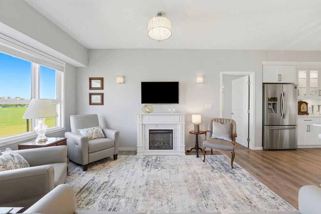 212-4150 Seton Drive Sw, Calgary, AB - Indoor Photo Showing Living Room With Fireplace
