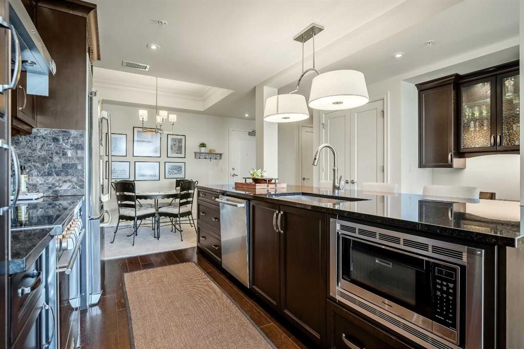 401-131 Quarry Way Se, Calgary, AB - Indoor Photo Showing Kitchen With Upgraded Kitchen