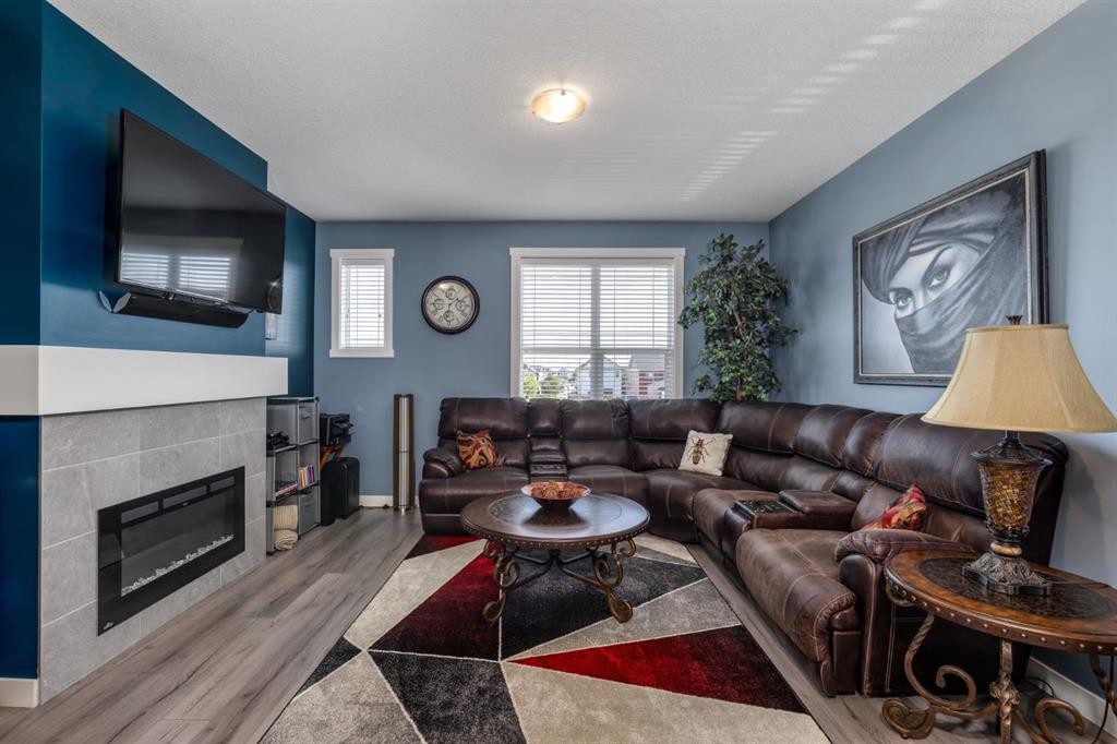 258 Copperleaf Way Se, Calgary, AB - Indoor Photo Showing Living Room With Fireplace