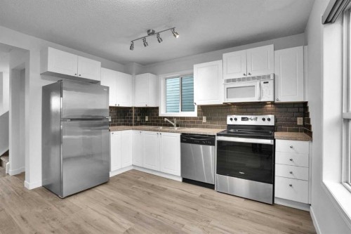 145 Bridleglen Road Sw, Calgary, AB - Indoor Photo Showing Kitchen With Double Sink