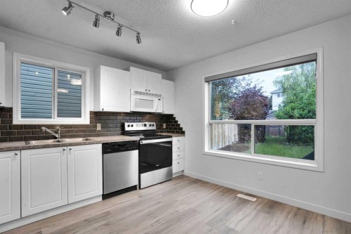 145 Bridleglen Road Sw, Calgary, AB - Indoor Photo Showing Kitchen With Double Sink