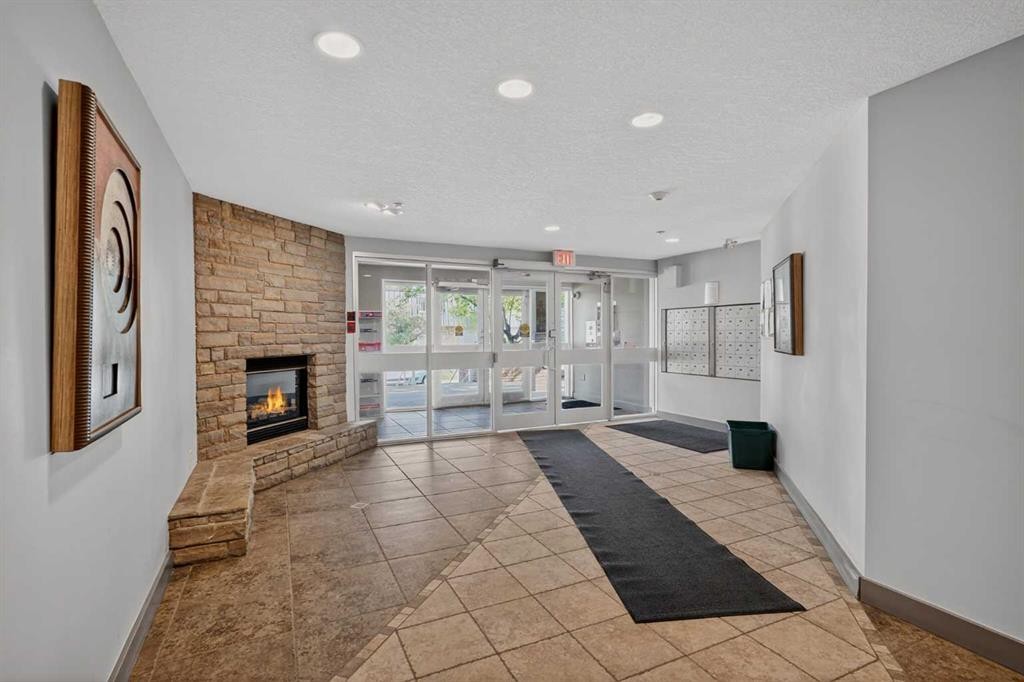 116-790 Kingsmere Crescent Sw, Calgary, AB - Indoor Photo Showing Other Room With Fireplace