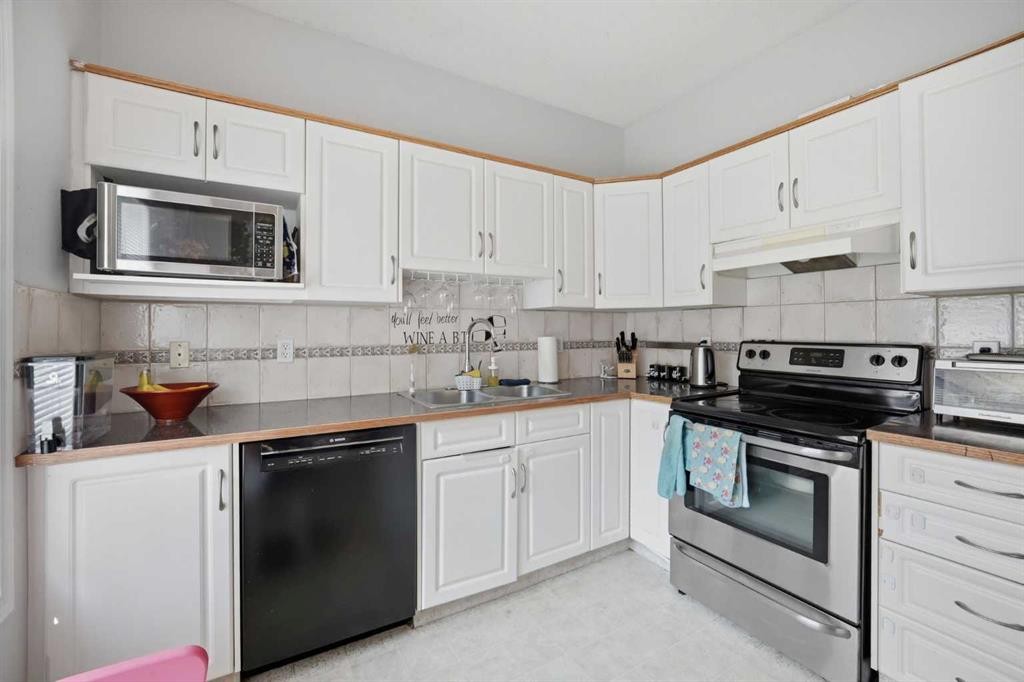 47 Bridlewood View Sw, Calgary, AB - Indoor Photo Showing Kitchen With Double Sink