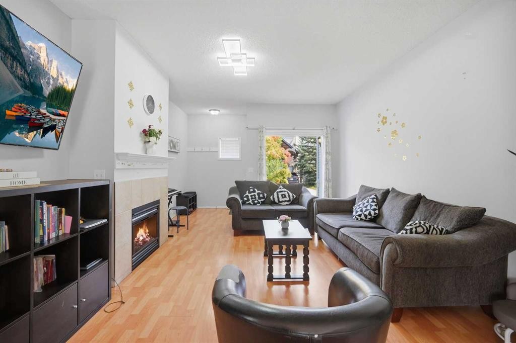 47 Bridlewood View Sw, Calgary, AB - Indoor Photo Showing Living Room With Fireplace