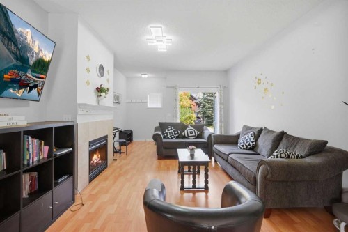 47 Bridlewood View Sw, Calgary, AB - Indoor Photo Showing Living Room With Fireplace