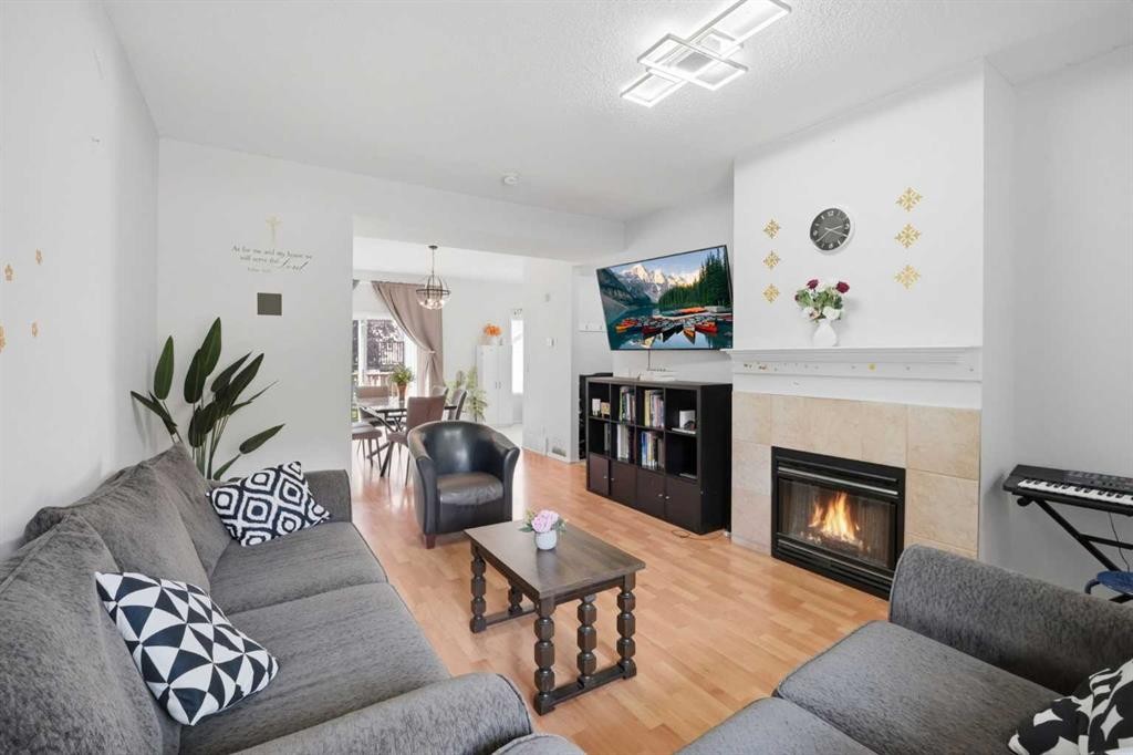 47 Bridlewood View Sw, Calgary, AB - Indoor Photo Showing Living Room With Fireplace