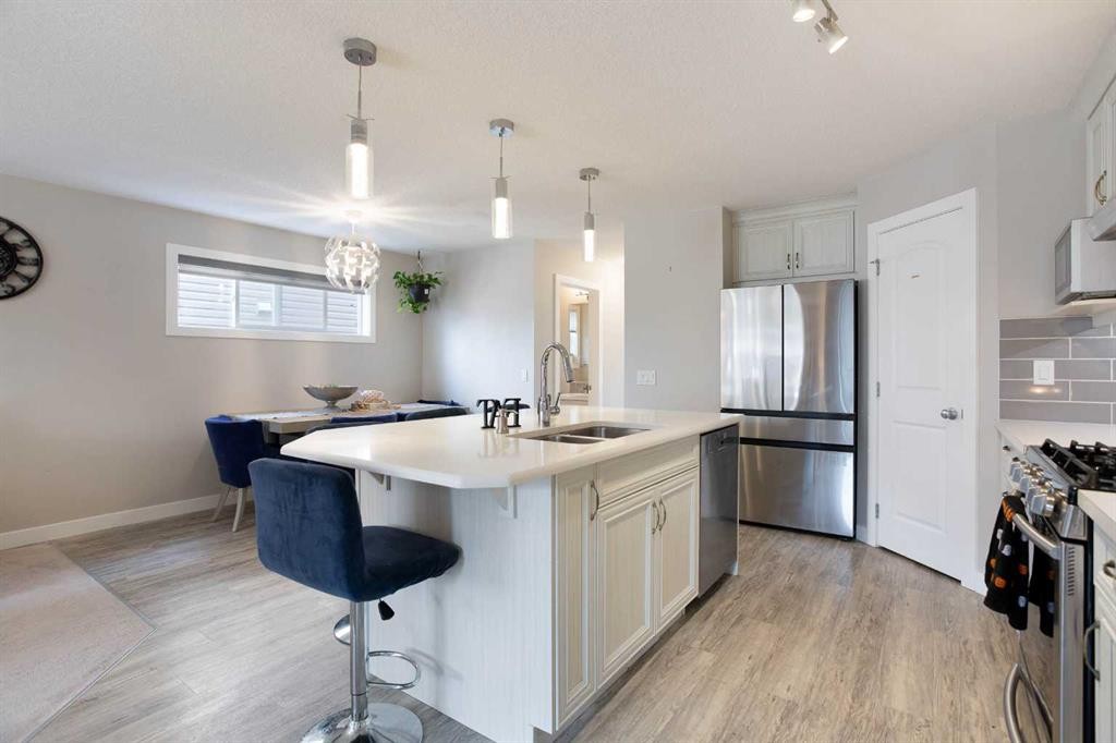 7 Emberside Hollow, Cochrane, AB - Indoor Photo Showing Kitchen With Double Sink With Upgraded Kitchen