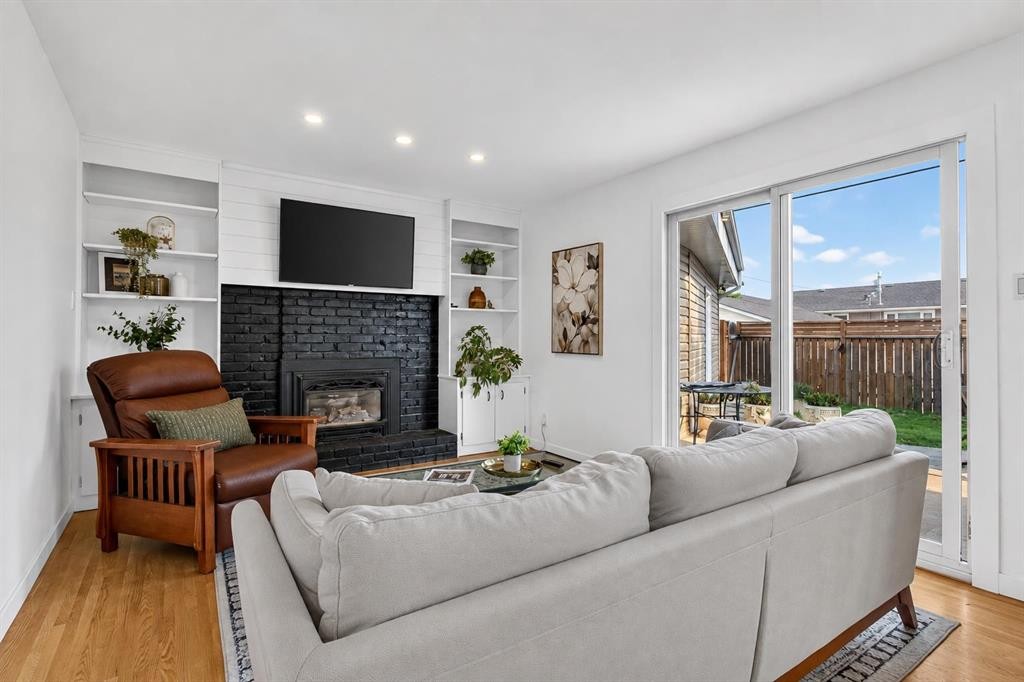 10719 Mapleglen Crescent Se, Calgary, AB - Indoor Photo Showing Living Room With Fireplace