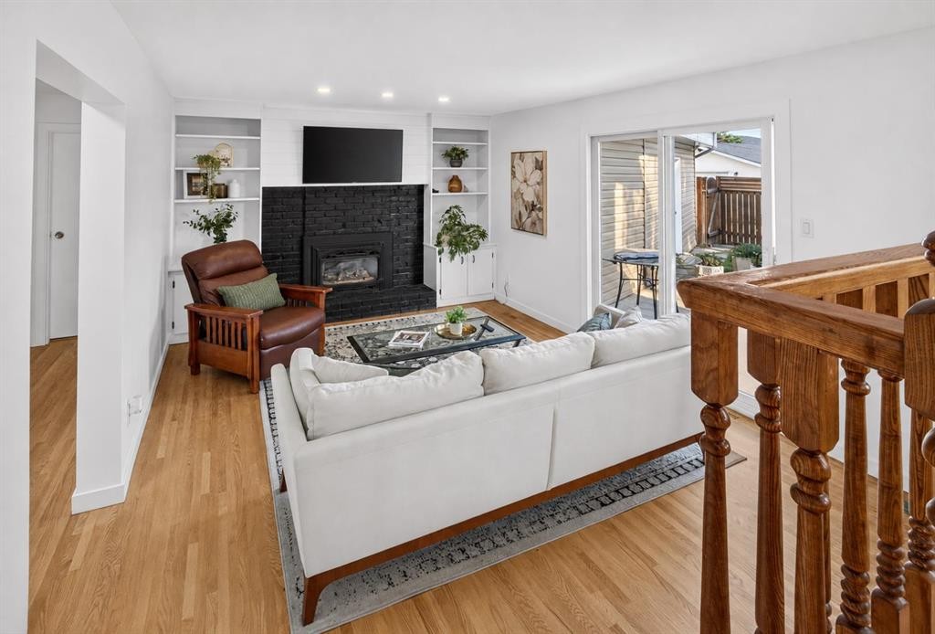 10719 Mapleglen Crescent Se, Calgary, AB - Indoor Photo Showing Living Room With Fireplace