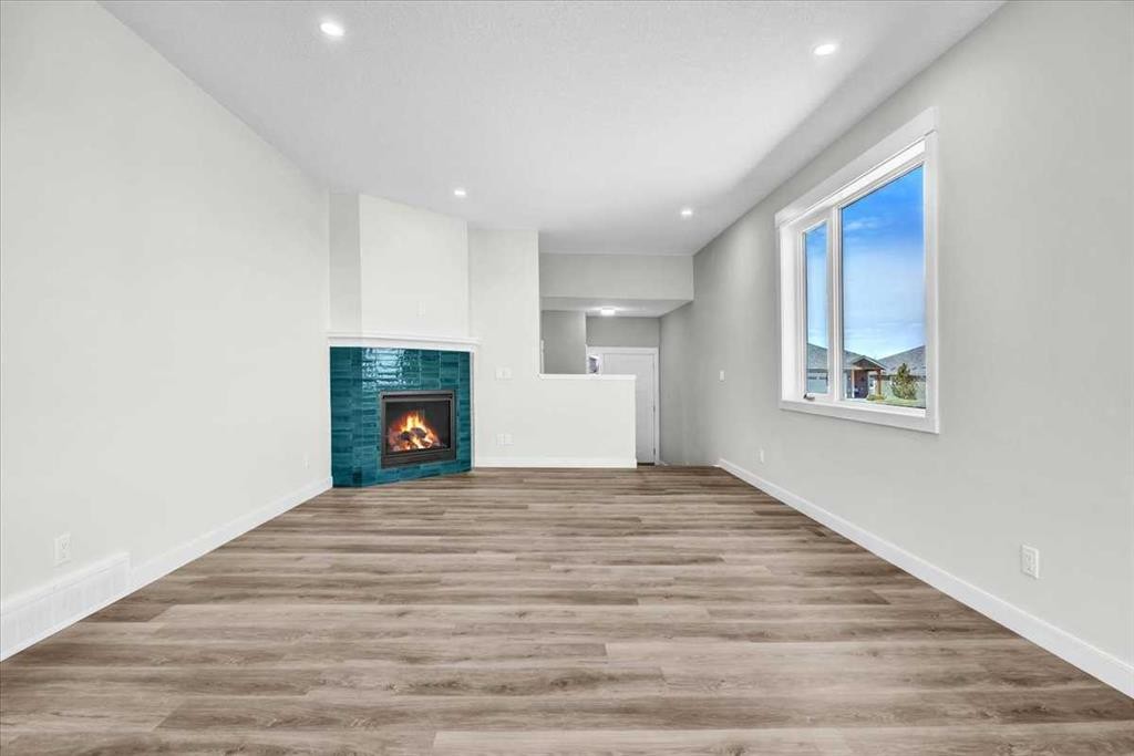 127 Westview Drive, Nanton, AB - Indoor Photo Showing Other Room With Fireplace