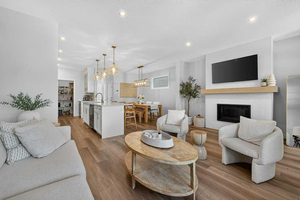 97 Rowmont Heath Nw, Calgary, AB - Indoor Photo Showing Living Room With Fireplace