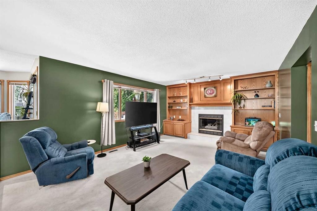 228 Arbour Ridge Way Nw, Calgary, AB - Indoor Photo Showing Living Room With Fireplace