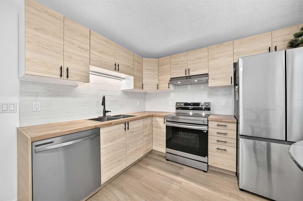 135 Woodsman Lane Sw, Calgary, AB - Indoor Photo Showing Kitchen With Double Sink