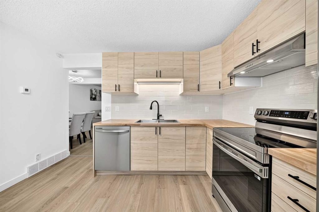 135 Woodsman Lane Sw, Calgary, AB - Indoor Photo Showing Kitchen With Double Sink