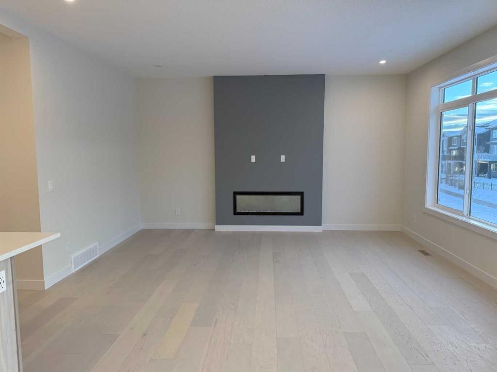 111 Sundown Crescent, Cochrane, AB - Indoor Photo Showing Other Room With Fireplace