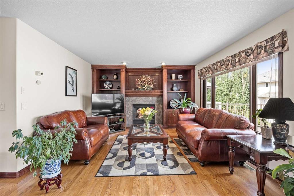 10385 Hamptons Boulevard Nw, Calgary, AB - Indoor Photo Showing Living Room With Fireplace