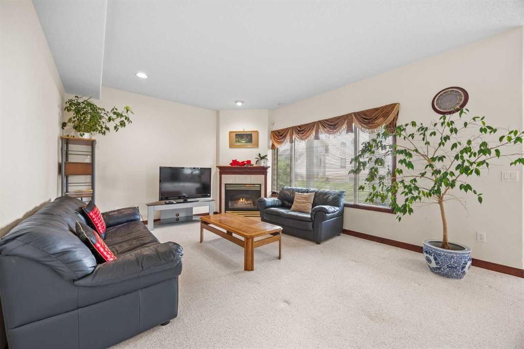 10385 Hamptons Boulevard Nw, Calgary, AB - Indoor Photo Showing Living Room With Fireplace