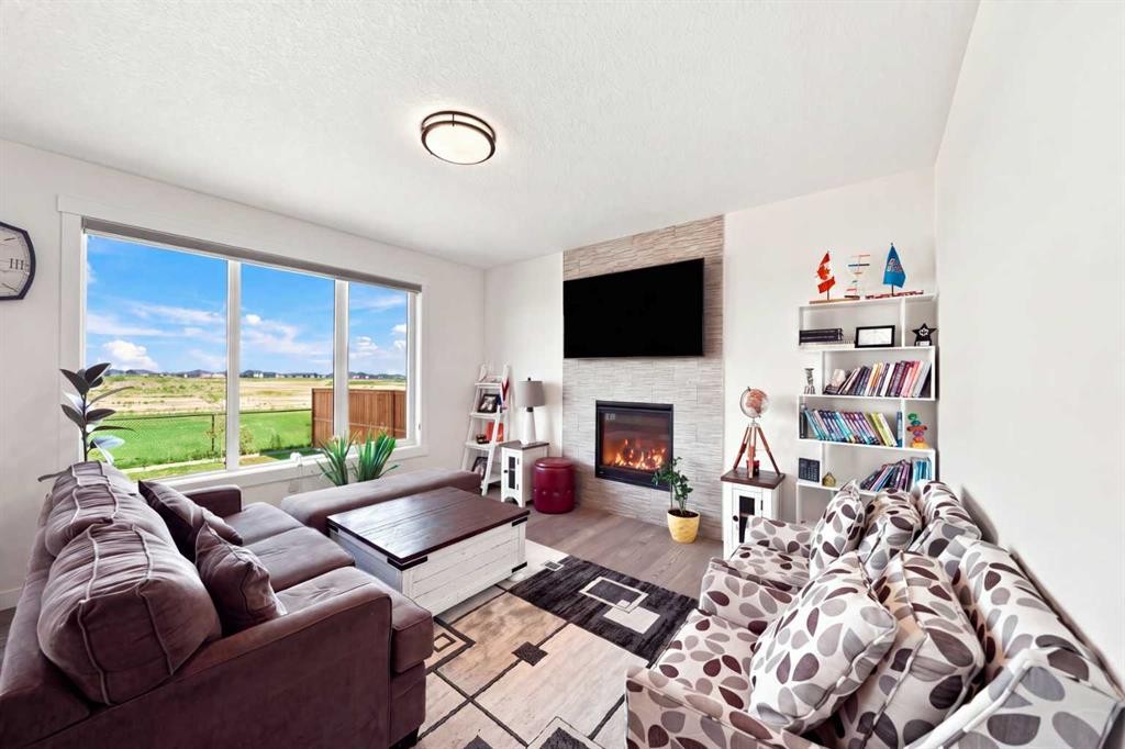 170 Chelsea Road, Chestermere, AB - Indoor Photo Showing Living Room With Fireplace