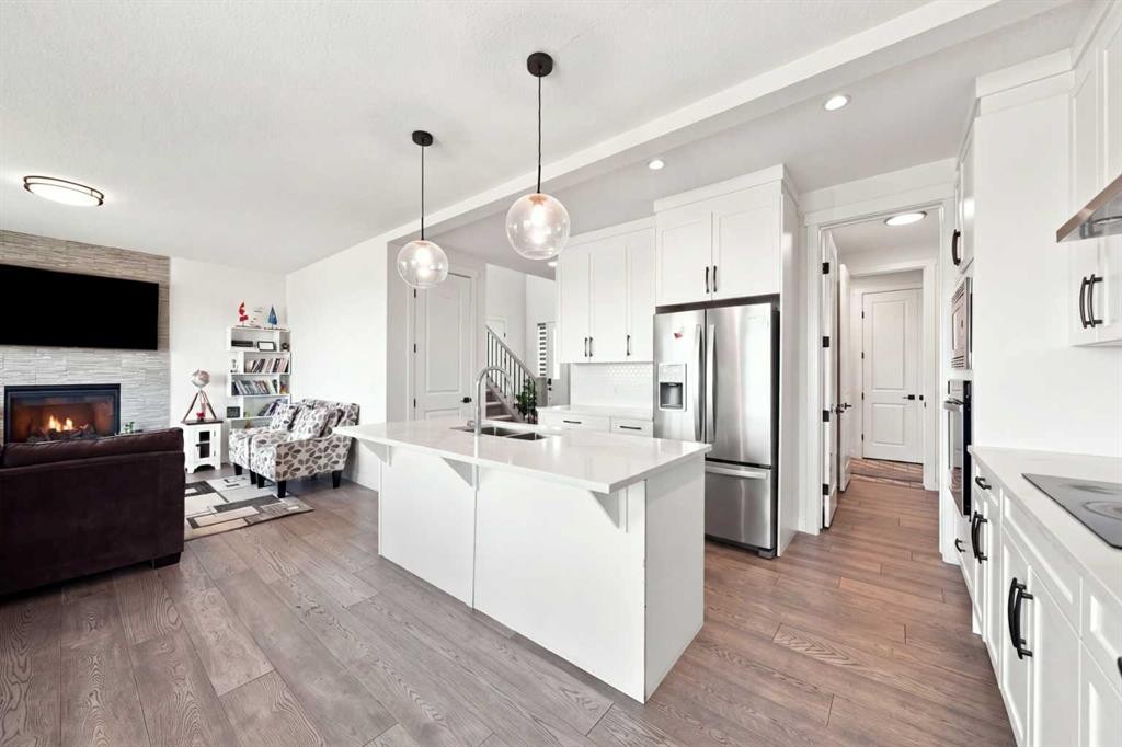 170 Chelsea Road, Chestermere, AB - Indoor Photo Showing Kitchen With Fireplace With Stainless Steel Kitchen With Double Sink With Upgraded Kitchen