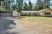 parking area next to the double garage, fenced front yard leads to entry of home