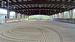 Steel-constructed, 80x200ft covered sand riding arena with lights, clay base.