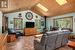 Living room with a wood stove, a skylight, wooden ceiling, high vaulted ceiling, and light tile floors