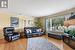 Living room with hardwood / wood-style flooring, a textured ceiling, and crown molding