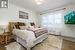 Master bedroom with ornamental molding and hardwood / wood-style floors