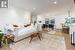 Living room featuring ornamental moldiand light hardwood / wood-style flooring