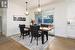 Dining area with light hardwood / wood-style floors, crown molding, and a notable chandelier