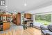 Kitchen with a kitchen breakfast bar, light hardwood / wood-style flooring, a baseboard heating unit, lofted ceiling, and appliances with stainless steel finishes