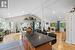 Kitchen featuring dark granite stone countertops, beamed ceiling, baseboard heating, and light hardwood