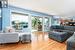 Living room with oak floors and sliders onto deck