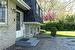 Door from kitchen and walk-up leading to stamped concrete patio in backyard