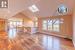 Soaring ceilings over hardwood floors with glimpses of Lake Huron through the room!